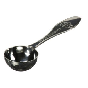 May include: A silver tea scoop with a long handle. The handle has the words "1 POT OF PERFECT TEA" engraved on it. The scoop is designed to hold one pot of tea.
