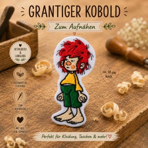 Op de afbeelding: Een geborduurde patch met een personage met felrood haar, een geel shirt en een groene broek. De patch heeft een witte achtergrond en bevat de tekst "GRANTIGER KOBOLD" en "Zum Aufnähen" met een hoogte-indicatie van "ca. 10 cm hoch".