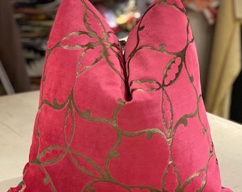 May include: A pink velvet pillow with a gold floral pattern. The pillow is square and has a decorative stitch around the edges.