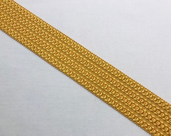 May include: Gold and light brown woven trim with a textured pattern.