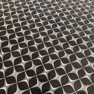 May include: A black and white geometric patterned rug with a repeating design of overlapping circles and ovals.