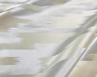 May include: White fabric with a subtle horizontal striped pattern. The fabric has a soft, silky texture.