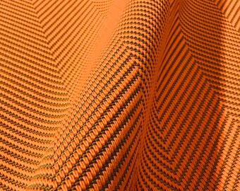 May include: Orange and brown fabric with a herringbone pattern. The fabric is woven with a textured, slightly raised design.