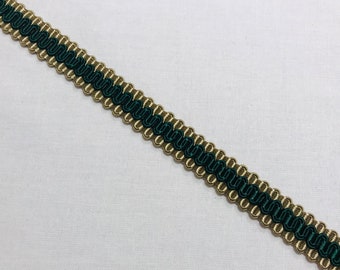 May include: Decorative trim with a dark green and gold design. The trim features a wavy, dark green center bordered by a gold, beaded edge. This trim is suitable for various craft and sewing projects.