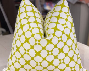 May include: A green and white patterned throw pillow with a floral design. The pillow is made of a soft, comfortable fabric and is perfect for adding a touch of color and style to any room.