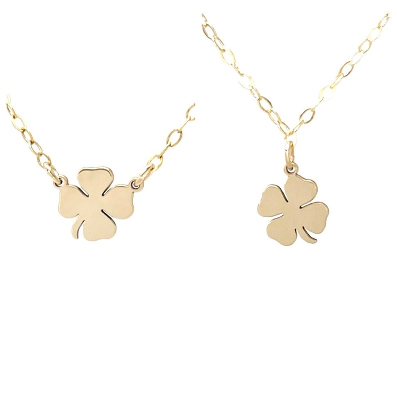 May include: A gold necklace with a four-leaf clover pendant. The necklace is made of a delicate chain and the pendant is a simple, flat design.
