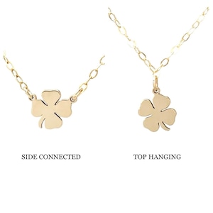 May include: Two gold necklaces with four-leaf clover charms. The necklace on the left has the charm connected to the chain on the side. The necklace on the right has the charm hanging from the top of the chain. The text "SIDE CONNECTED" is below the left necklace and the text "TOP HANGING" is below the right necklace.