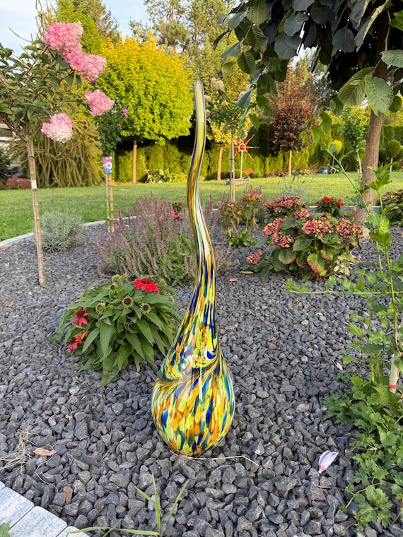 A 65cm hand-blown glass flame sculpture bursting with tropical jungle colors — the kind of garden art that stops guests mid-sentence and makes you look like you curate contemporary galleries.
