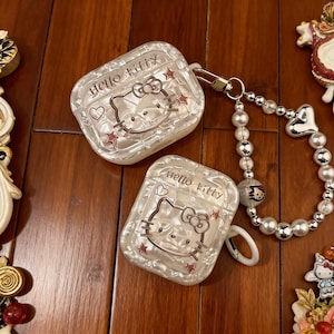 Custodia Shell Hello Kitty per AirPods Pro con cinturino decorato con perline