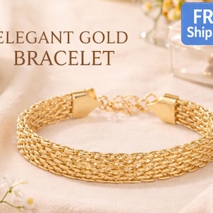 May include: An elegant gold bracelet with a woven design. The bracelet is made of gold-colored metal and features a secure clasp. The text "ELEGANT GOLD BRACELET" is displayed above the bracelet.