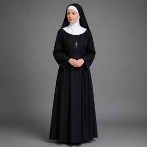 May include: A person in a traditional black nun's habit, comprising a long-sleeved black dress, a white wimple, and a black veil. A silver cross hangs from a necklace. The person is standing against a grey background. The habit is a symbol of religious devotion.
