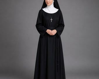 May include: A full-length image of a person wearing a traditional black nun's habit. The habit includes a long-sleeved black dress, a white wimple, and a black veil. A silver cross hangs from a necklace. The person is standing against a gray background.
