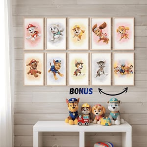 May include: A set of framed Paw Patrol character prints and plush toys. The prints depict cartoon dogs in action poses, set against pastel backgrounds. The word "BONUS" is written below the prints. The plush toys are displayed on a white table.
