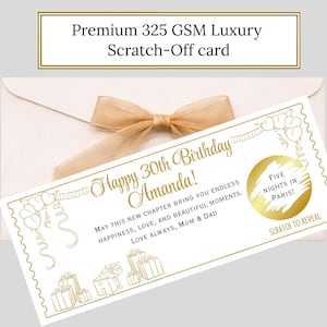 May include: A white scratch-off card with gold text and accents, featuring the message "Happy 30th Birthday Amanda!" and a "Five Nights in Paris!" reveal. The card is presented with a cream envelope and a gold ribbon.