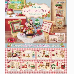 May include: Miniature set of a country strawberry cafe, featuring a table setting with a small cake, pastries, and a teapot. The set includes chairs with decorative pillows, a small hourglass, and a sign that says "The Country Strawberry Cafe".