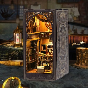 May include: A detailed wooden book nook with an interior scene of a library or study, illuminated by warm lighting. The exterior features intricate carvings and a decorative design. The book nook is a miniature diorama, perfect for book lovers.