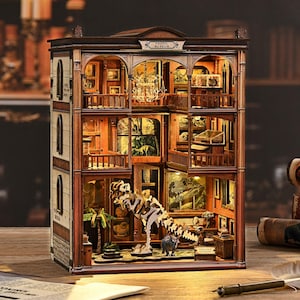 May include: A detailed wooden model of a fossil museum, featuring multiple floors with exhibits, a dinosaur skeleton, and the text "Fossil Museum". The model has intricate architectural details and warm interior lighting.