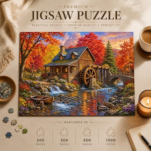 May include: A jigsaw puzzle box featuring a landscape illustration of a wooden watermill cabin by a stream during autumn. The scene includes vibrant orange and red trees, a stone bridge, a small boat, and ducks. Text reads PREMIUM JIGSAW PUZZLE.