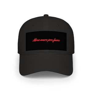 May include: Black baseball cap with a curved peak. The cap has a rectangular patch with the red script "More amor por favor". A classic style, suitable for casual wear.