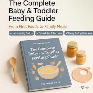 May include: A blue hardcover book titled The Complete Baby and Toddler Feeding Guide with illustrations of a bowl, spoon, and vegetables. Beside the book are a wooden spoon, two small glass jars with tan lids, and a light peach-colored baby bib.