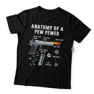 May include: A black t-shirt featuring a graphic titled ANATOMY OF A PEW PEWER. The design displays a silver handgun with labels like LOOKY AIMY THINGY, PEW PEW TUBE, MAGIC LIGHT, FAST PEW, CLICKY BANG BUTTON, PEW STORAGE, and PEW HOLES with bullets.
