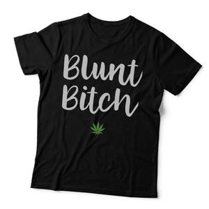 May include: A black short-sleeved t-shirt featuring the text Blunt Bitch in a light grey script font. Below the text is a small, detailed green cannabis leaf graphic. The shirt is displayed flat against a plain background with the word black.