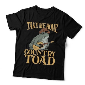 May include: A black short-sleeved t-shirt featuring a graphic of a toad wearing a brown cowboy hat and playing an acoustic guitar. The text above the toad reads "TAKE ME HOME" and the text below reads "COUNTRY TOAD" in a distressed gold font.