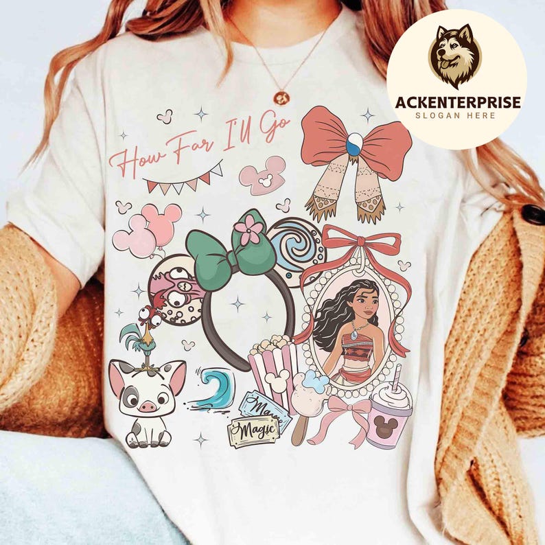 May include: Cream-colored t-shirt featuring a colorful graphic design with the text "How Far I'll Go." The design includes cartoon characters, bows, a portrait, and other decorative elements. The shirt has a round neckline and short sleeves.