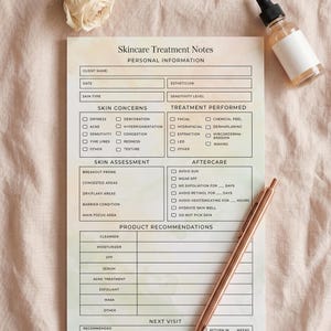 May include: A skincare treatment notes sheet with sections for personal information, skin concerns, and treatment performed. A rose gold pen, a small bottle of serum, and a rose are on the pink surface.