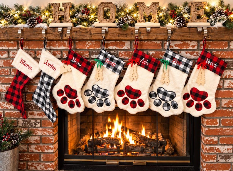 May include: Seven personalized Christmas stockings hanging from a wooden mantel. The stockings feature red and black or white and black buffalo plaid cuffs and paw print appliques. Each stocking is embroidered with names including Warren, Jordan, Beau, Scott, Ash, Finn, and Brock.