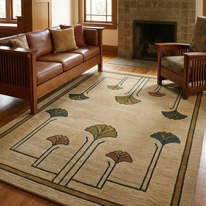 May include: A rectangular area rug with a beige background featuring a dark green linear border and stylized floral motifs in shades of teal, rust, and olive green. The design includes long, thin stems extending from the edges toward the center.