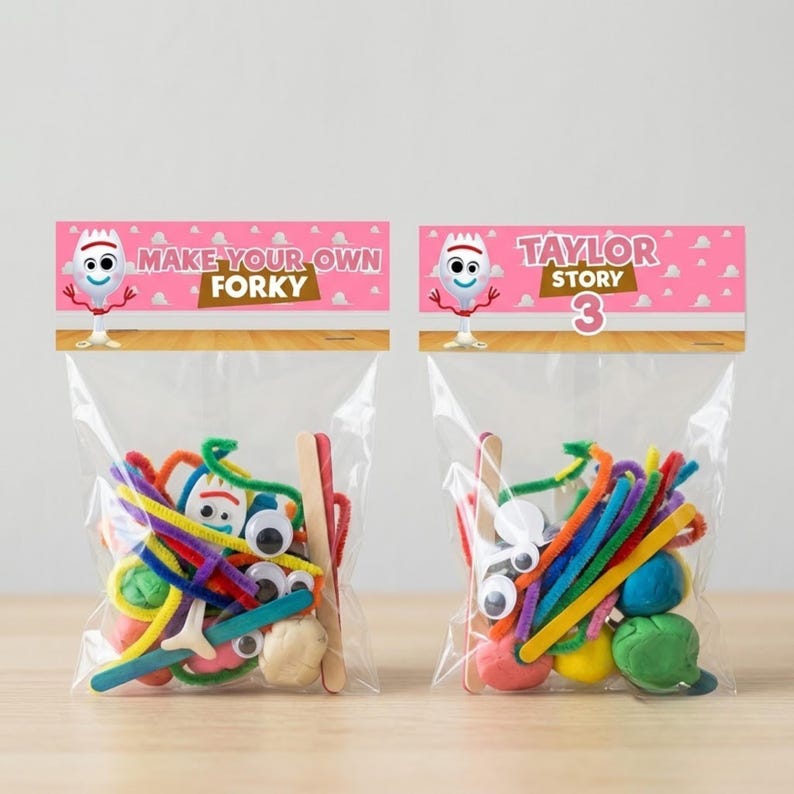 Two completed party favor bags side-by-side on a wooden surface against a plain grey background. The bag on the left has a pink topper reading "Make Your Own Forky," and the bag on the right reads "Taylor Story 3." Both transparent bags are filled with vibrant craft materials like multi-colored pipe cleaners, popsicle sticks, googly eyes, and colorful molding clay.