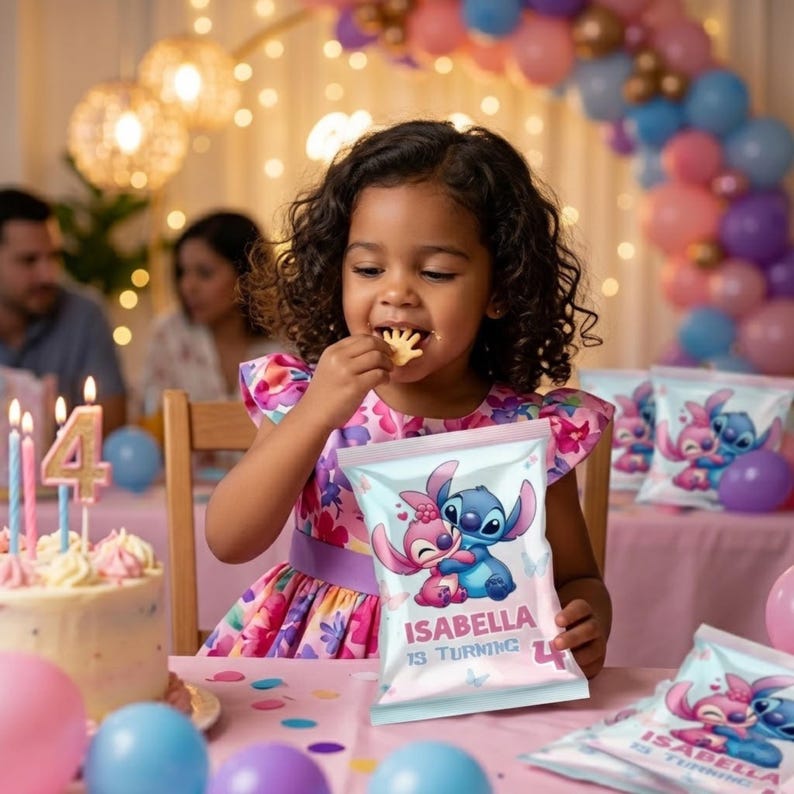 A lifestyle mockup showing a young girl with curly hair sitting at a birthday party table, eating a snack. She is holding a custom-printed Stitch and Angel chip bag that reads "ISABELLA IS TURNING 4." The background is filled with pastel pink, blue, and purple balloons, warm festive string lights, a birthday cake with a number 4 candle, and other party guests.