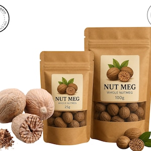 May include: Two brown kraft paper stand-up pouches containing whole nutmeg, labeled 25g and 100g. The labels feature the text NUT MEG WHOLE NUTMEG and an illustration of nutmegs with leaves. Loose whole nutmegs and a pile of grated nutmeg are visible.