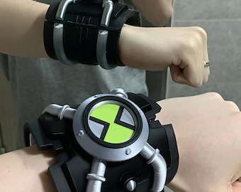 May include: A black wrist-worn device featuring a circular face with a bright lime green center and a silver-colored frame. The band is wide and black with silver-colored piping accents that extend from the central circular component.