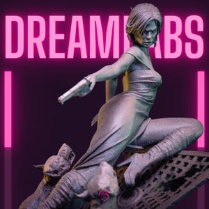 May include: A detailed statue of a woman in a flowing dress, holding a gun, with two dog-like creatures at her feet. The statue is a metallic gray color, set against a dark background with the text "DREAMBS" in bright pink.