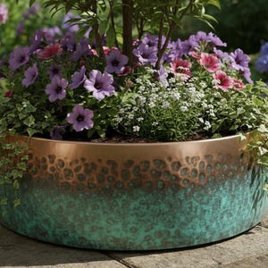 May include: A large, round copper and verdigris planter filled with vibrant purple, pink, and white flowers and greenery. The planter has a textured surface and is placed outdoors. Other terracotta pots are in the background.