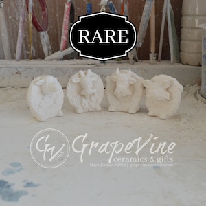 May include: Four white ceramic figurines of farm animals, including a cow, a sheep, and a goat. The figurines are arranged in a row on a white surface. The word "RARE" is written in black letters on a black background above the figurines. The text "GV 1998 Grapevine ceramics & gifts Hays, Kansas 67601 | grapevineceramics.com" is written in black letters on a white background below the figurines.