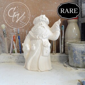 May include: White ceramic figurine of Santa Claus holding a sack and a bird. The figurine is marked "Made in the USA" and "G&J 1998". The figurine is labeled "RARE".
