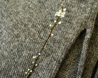 Grey poncho knitted in natural wool