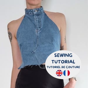May include: A light blue denim halter top with a high collar and button fastening. The top has a raw hem and is worn with a black skirt. The image includes the text "SEWING TUTORIAL" in a white oval.
