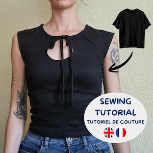 Può includere: Un top nero senza maniche con scollo rotondo, un'apertura a goccia e due sottili laccetti in tessuto. Il capo è mostrato accanto a una piccola immagine di una t-shirt nera semplice con una freccia che indica la versione senza maniche.