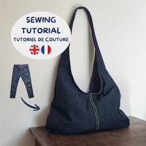 Può includere: Una borsa hobo in denim blu scuro con una tracolla singola e una cucitura verticale bianca. Un grafico mostra un paio di jeans con una freccia che punta verso la borsa, etichettato con il testo SEWING TUTORIAL TUTORIEL DE COUTURE.