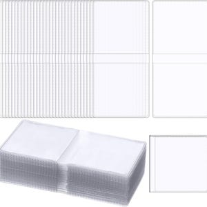 May include: A collection of clear, transparent plastic card holders. The holders are rectangular with a pocket on each side, designed to hold cards. The image shows multiple stacks and arrangements of the holders, highlighting their organizational potential.