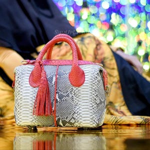 May include: A set of three ceramic mugs with a speckled, matte finish in cream, light grey, and dark grey. Each mug has a simple, minimalist design, suitable for coffee or tea.