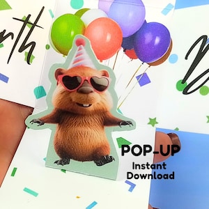 May include: A pop-up birthday card featuring a cartoon groundhog wearing heart-shaped sunglasses and a party hat, holding balloons. The card has the words "POP-UP Instant Download". The card is decorated with confetti and stars.