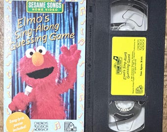 VHS de Elmo cantando y adivinando (Póster incluido) de Barrio Sésamo – Inspeccionado, limpiado y rebobinado