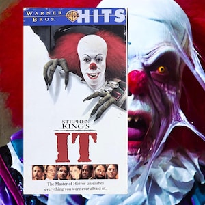 May include: A VHS tape for Stephen King's "IT" movie, featuring a menacing clown with red hair and a red nose. The tape is labeled "Warner Bros. Hits" and includes the tagline "The Master of Horror unleashes everything you were ever afraid of."
