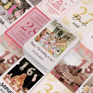 May include: A collection of personalized birthday cards and photo tins. The cards feature names, dates, and ages, with a pink and gold color scheme. One tin has a photo and the text "Happy 21st birthday to her!" and the date.