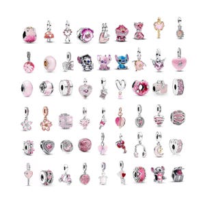 May include: A collection of assorted metal and enamel charms in various shapes, including hearts, flowers, animals, and characters. The charms feature pink, silver, and rose gold tones, with some designs incorporating small clear stones and intricate detailing.
